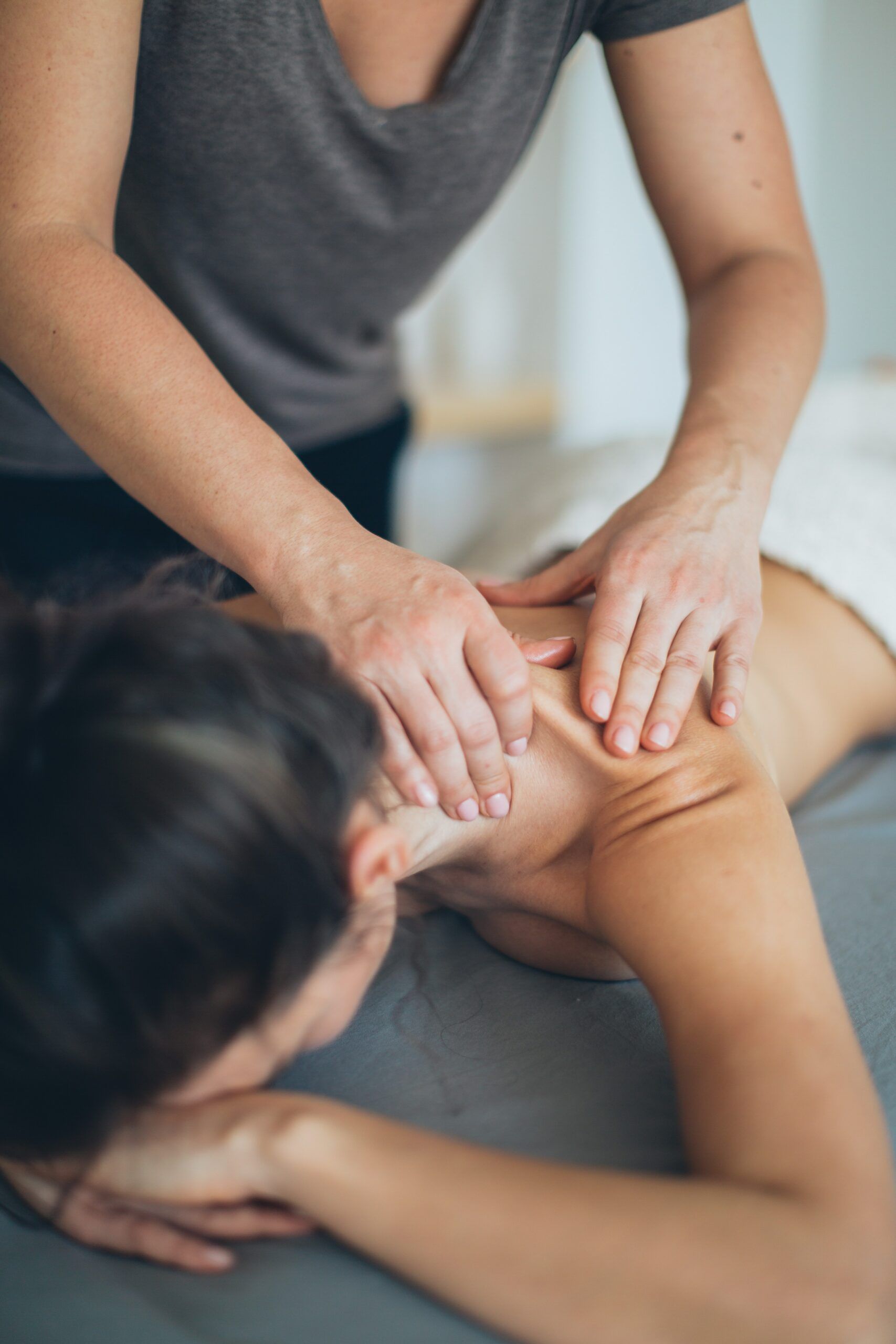 woman getting a massage in the treatment room Hotel Le Faucigny