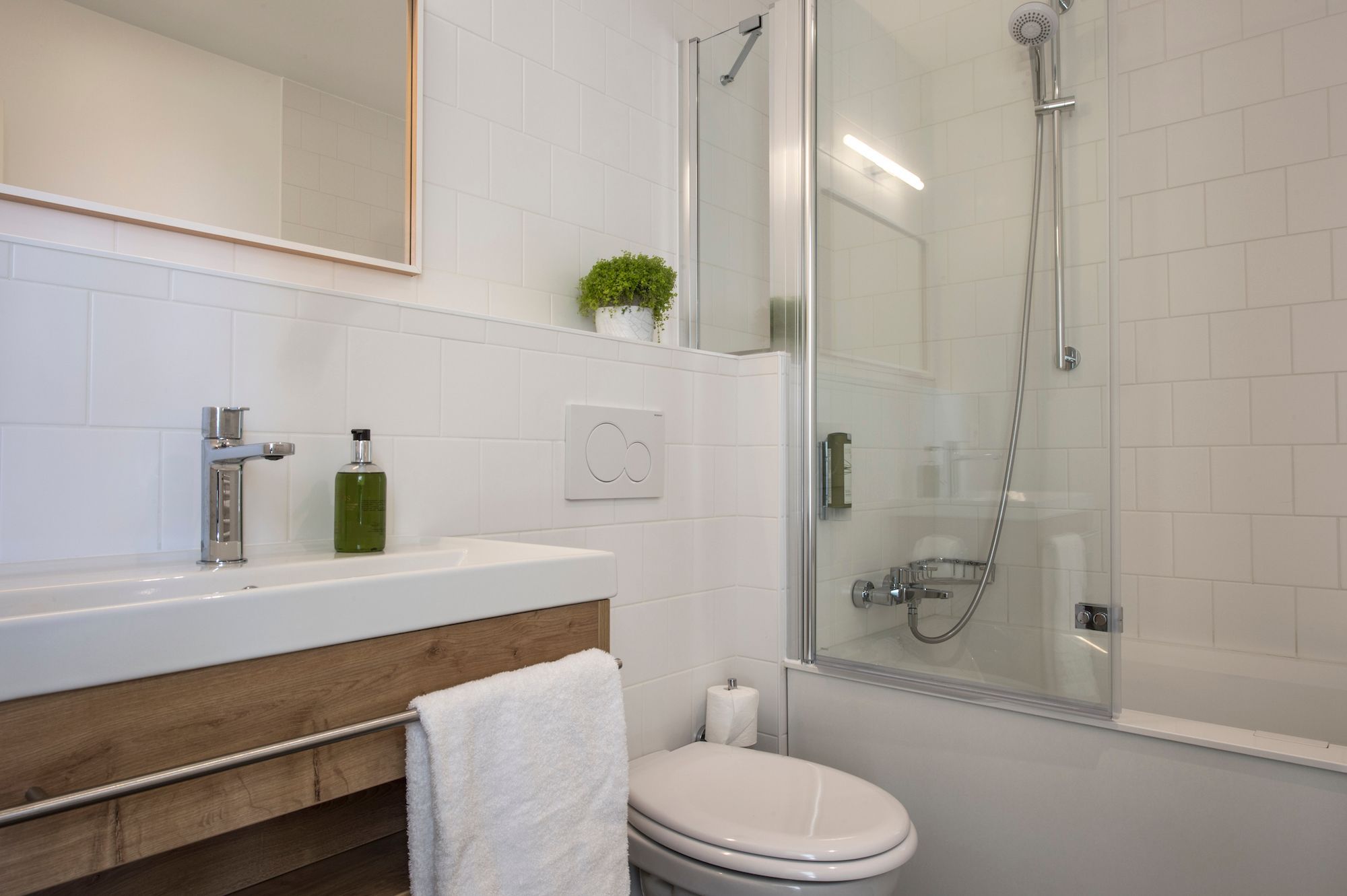 bathroom with bath, toilet and washbasin wooden furniture
