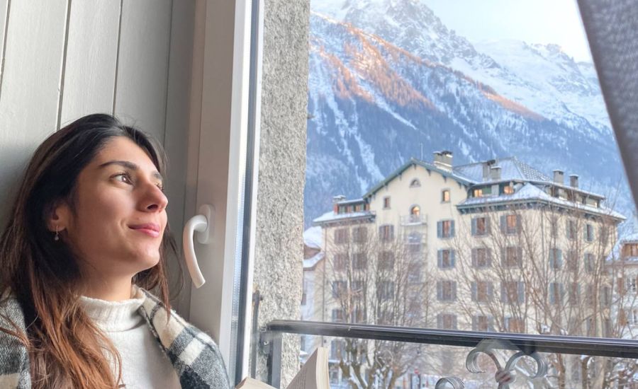 woman looking out of a comfort bedroom window